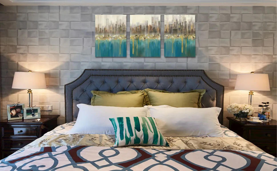 Panoramic ocean sunset triptych above a bedroom headboard